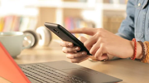 Student hands using mobile phone at home Stock Footage 127993389