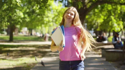Student happy dancing with books outside Stock Footage 161426589