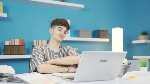Student happy with what he sees on laptop. Homework. Stock Footage 237042932