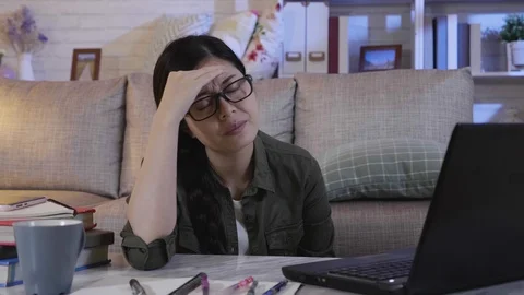 Student having headache while staying up late Video stock 100275018