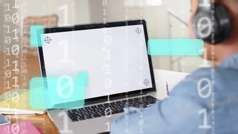 Student with headset sitting at table, laptop booting, binary UI flowing over Stock Footage 335465884