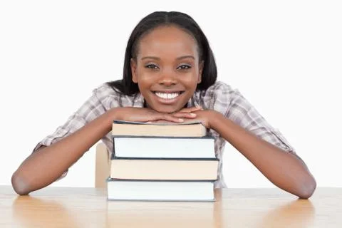 Student with her chin on a stack a book 스톡 사진