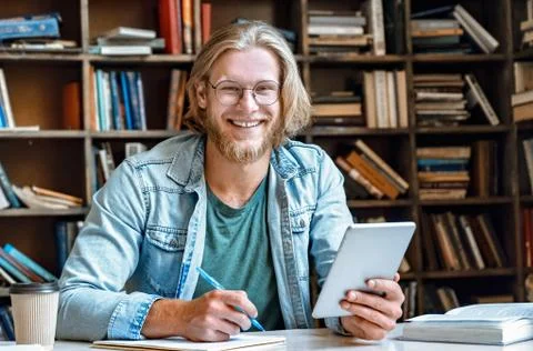 Student hold modern tablet make notes in notebook empty smile at camera 스톡 사진