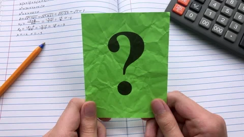 A student  holding a green paper note with a question mark on it. Stock Footage 311200946