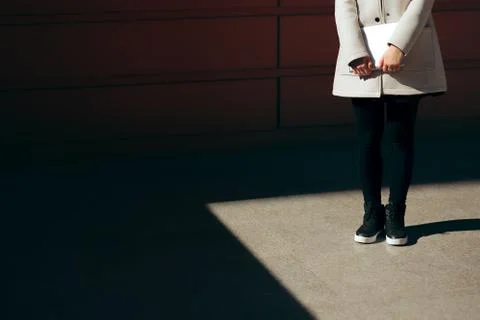 Student Holding PC Tablet Standing in Spotlight Wearing Sport Shoes Foto stock