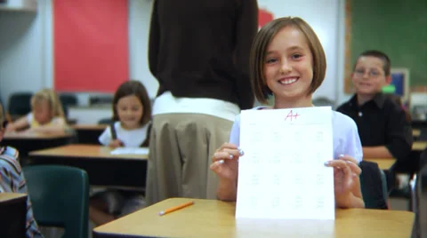 Student holds up paper with an A+ | Stock Video | Pond5