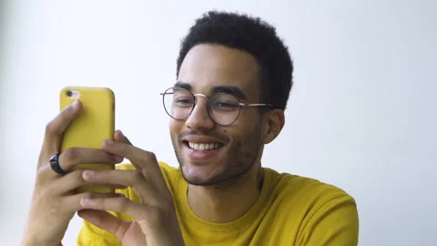 The student holds a smartphone in his hands. Stock Footage 165835629