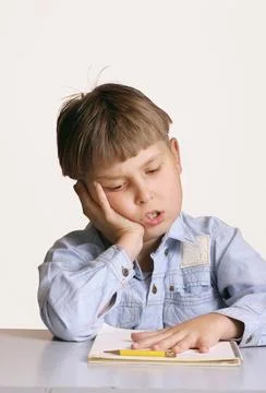 Student with homework schoolwork A child sitting at a desk with homework o... Stock Photos