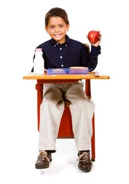 Student: hungry boy holds up apple from lunch Stock Photos