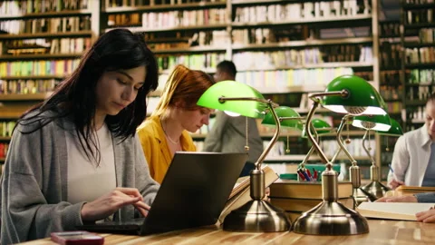 Student ignoring laptop work and notes after phone notification Stock Footage 336358865