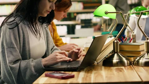 Student ignoring laptop work and notes after phone notification Stock Footage 336360675