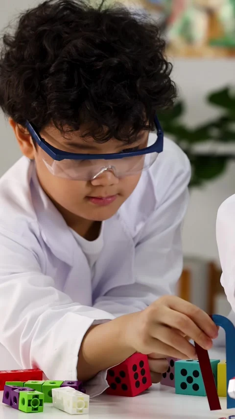 Student in Lab Coat Performing Magnetism Experiment in Science Class Stock Footage 341455176