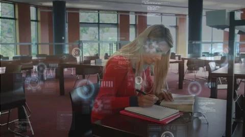 Student leaning, glancing at book, taking notes while AR HUD overlays growing Stock Footage 330144203