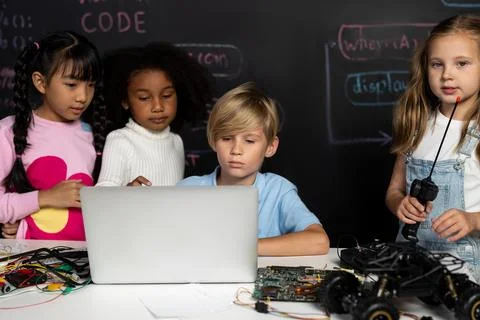 Student learn about coding robotics car in STEM class with attention. Erudition. Stock Photos
