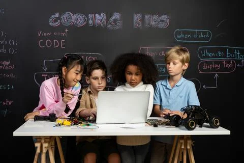 Student learn about coding robotics car in STEM class with attention. Erudition. Stock Photos