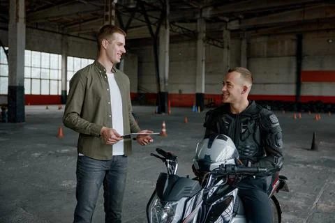 Student learning how to drive motorcycle with one hand Stock Photos