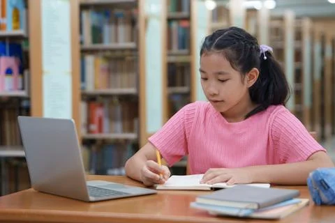 Student learning online class by using laptop computer and writing notebook a 스톡 사진