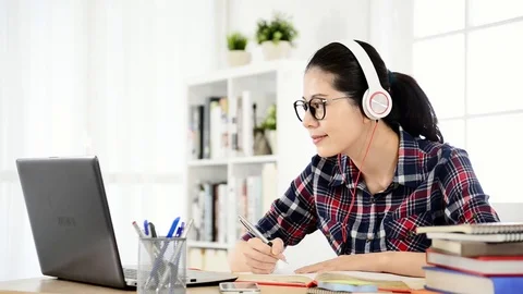 Student learning online with headphones Stock Footage