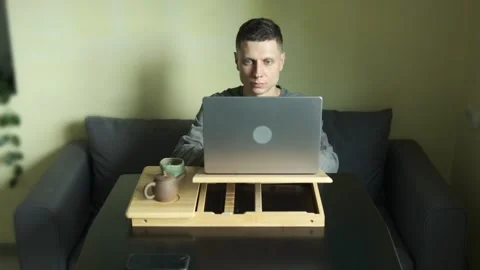 Student learning online at laptop in authentic home interior. Stock Footage 316627688