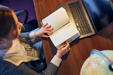 Student learning remotely from home. Young woman having classes online, mak.. Foto stock