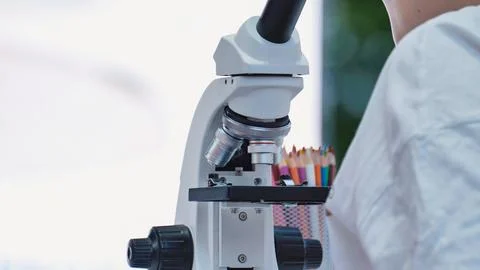 Student learning science using microscope in a school laboratory for education 写真素材