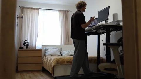 Student learns a new field while taking notes and studying financial charts Stock-Footage 346881959