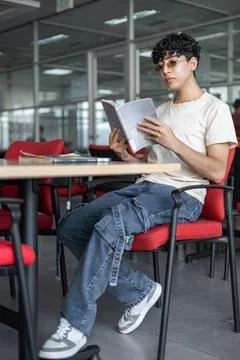 Student in library sitting reading Stock Photos