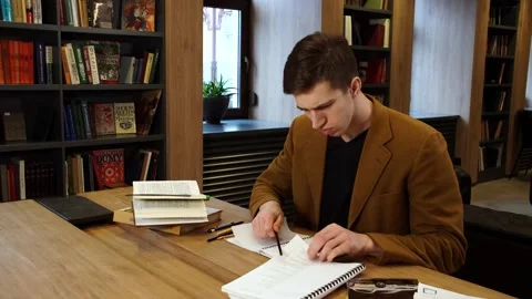 Student in the library studying books, panoramic view Stock Footage 155962973
