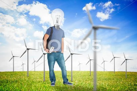 Student with a light bulb head in the middle of wind turbine field Stock Photos