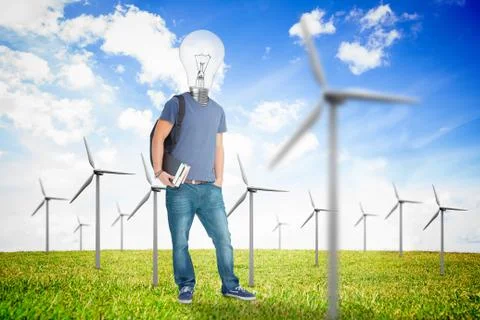 Student with a light bulb head in the middle of wind turbine field Stockfoto's