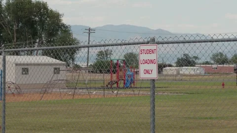 Student Loading Area and School Playground Behind Chain-Link Fence Stock Footage 340392582