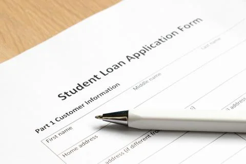 Student loan application form wth pen on desk background Stock Photos