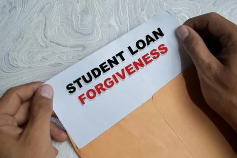 Student loan forgiveness text on document above brown envelope. Stock Photos