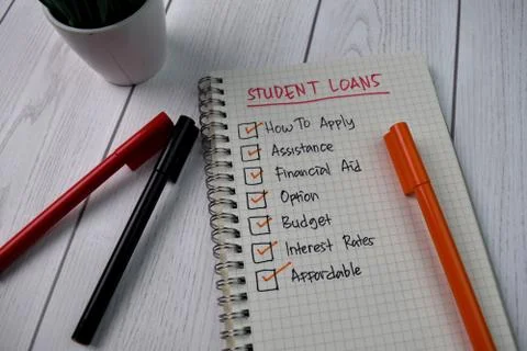 Student Loans write on a book. Supported by an additional services Stock Photos