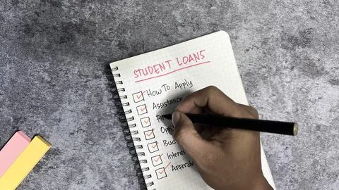 Student Loans write on a book. Supported by an additional services Fotos Stock