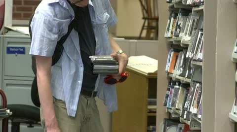 Student looking at DVR's in the library Stock Footage 10774669