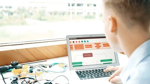 Student looking at laptop screen while coding engineering prompt. Edification. 스톡 사진