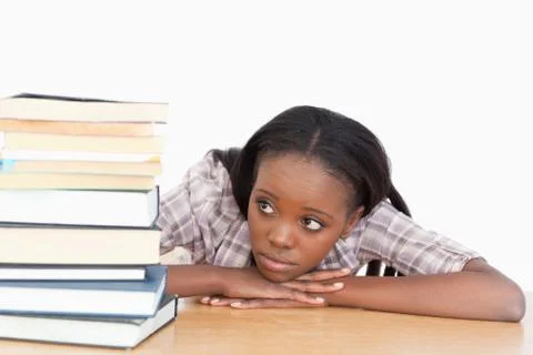 Student looking at a stack of books Stock Photos