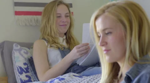 Student Looks At Laptop, Asks Her Friend A Question, She Answers Stock Footage 62746534