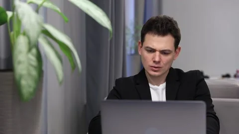 Student looks at laptop screen display celebrating admission to university Stock Footage 168835232