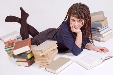 Student lying between books Stock Photos