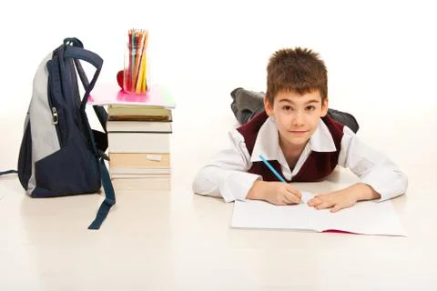 Student lying on floor and doing homework 스톡 사진