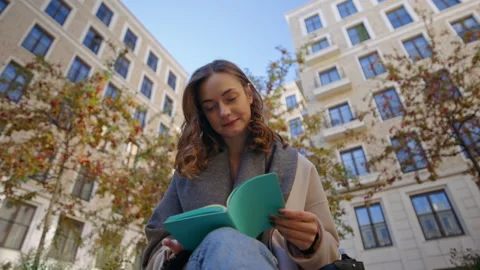 Student make paper notes in diary on street 動画素材 170008090