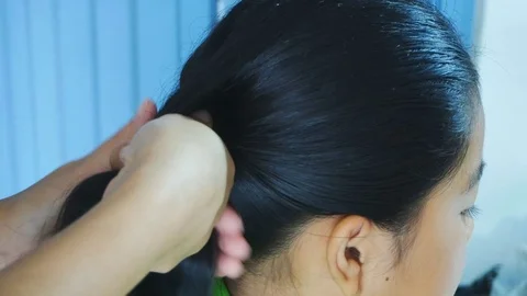 Student makes a braid by her mother Stock Footage 79736162