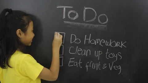 Student making to do list on the chalkboard Video stock 112730981