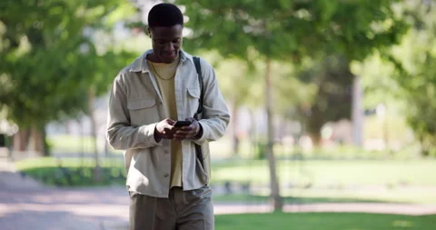 Student, man and walking with phone at college for study break, text message or Stock Footage 323256253