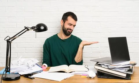 Student man holding copyspace with doubts 스톡 사진