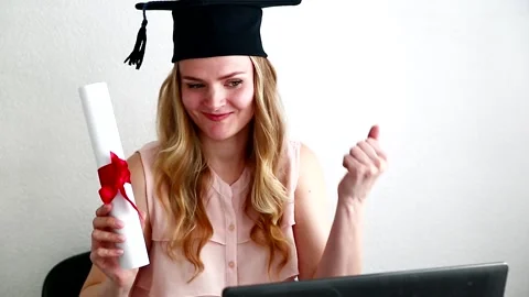 Student in masters after exam behind a laptop. Online education, graduation Stock Footage 152210896