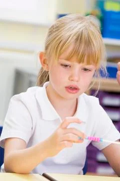 Student in math class with counting beads Stock Photos