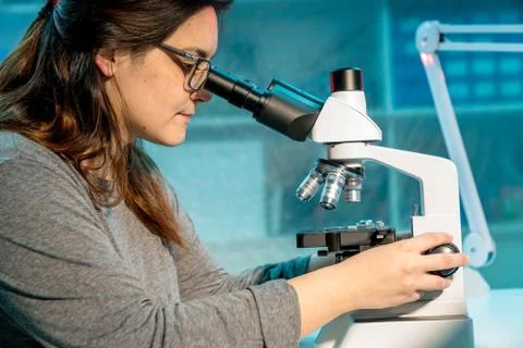 Student with microscope  test tubes and notebook in lab Stock Photos